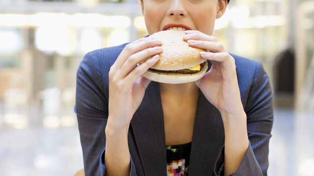 Woman eating a hamburger