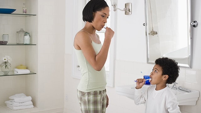 Mother and son brushing their teeth 