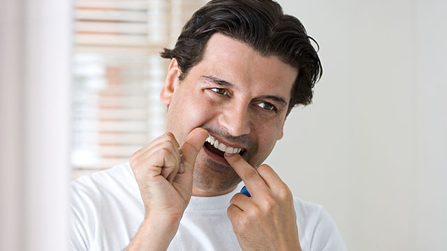 man flossing