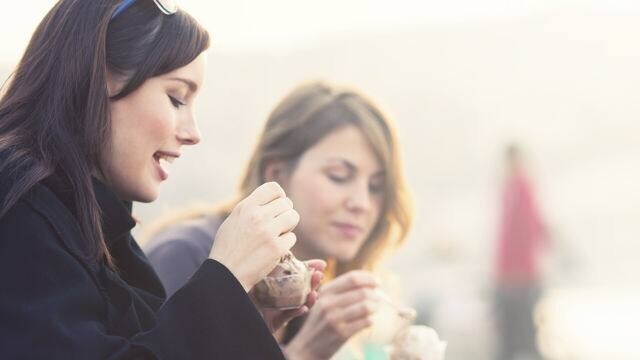 two friends eating ice-cream two friends eating ice-cream